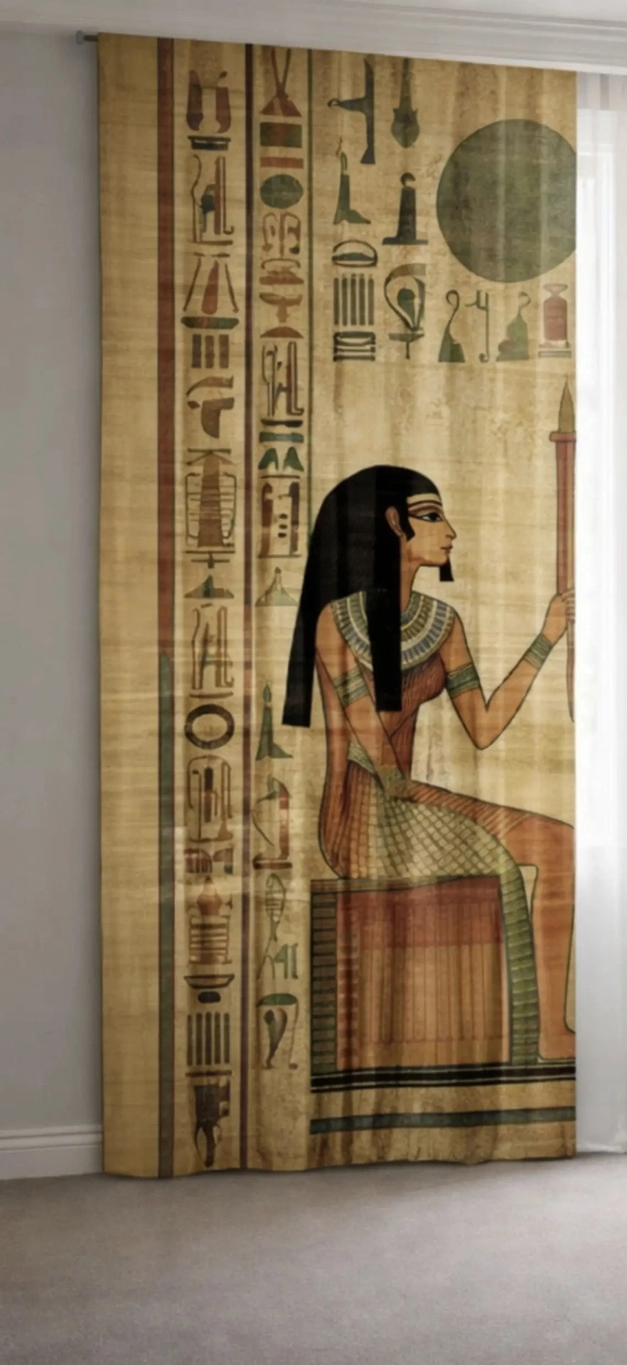 left view of Decorative curtain with Egyptian-themed design featuring hieroglyphics and a figure.