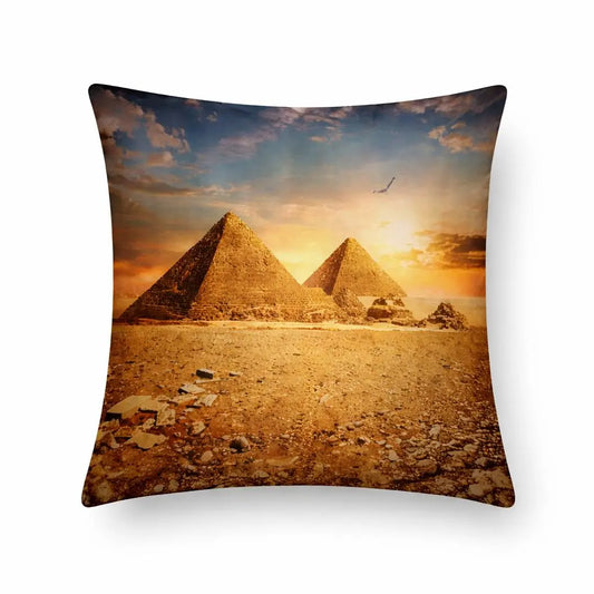 Decorative pillow with pyramids and sunset design on a white background